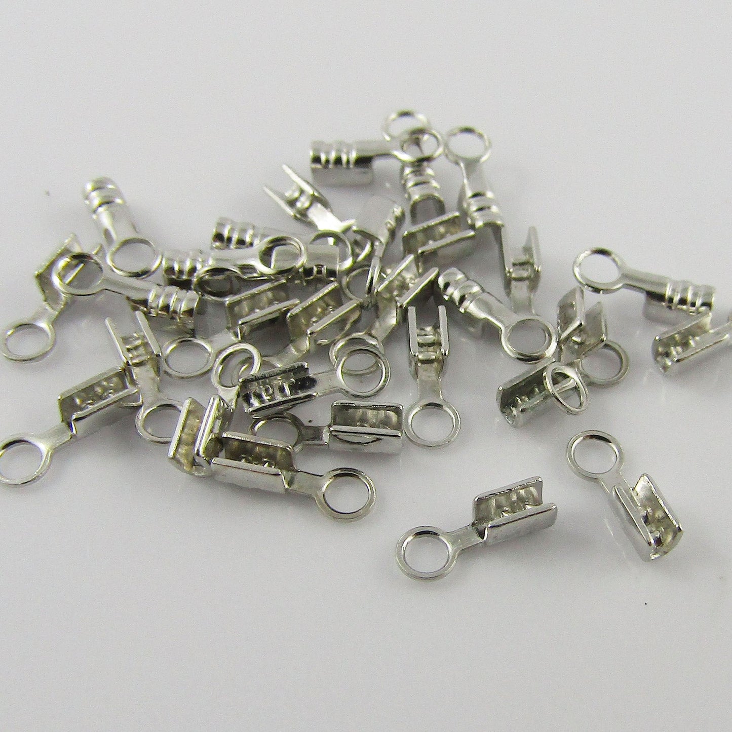 25 Sets (50pcs) Iron Fold Over Cord Crimp Ends 7x2mm Hole 1.5mm Silver Tone